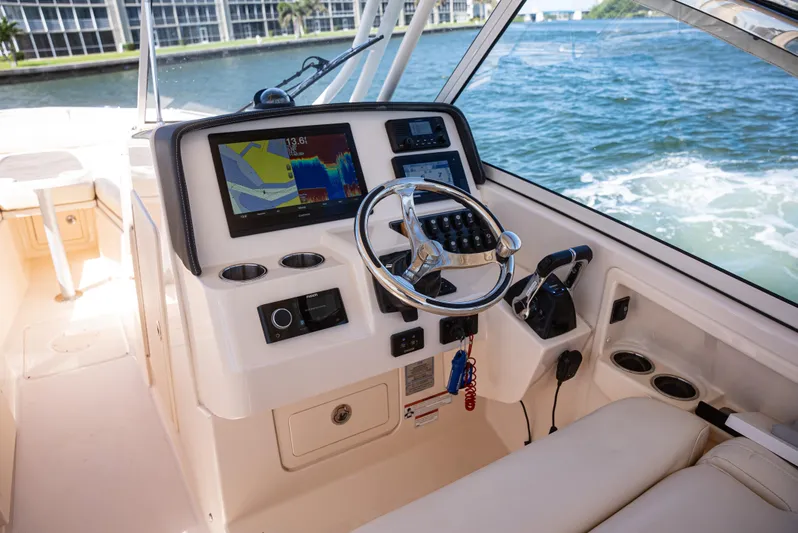  Yacht Photos Pics 2020 Grady-White Freedom 285 boat dashboard with navigation system and steering wheel.
