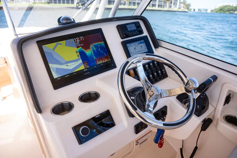  Yacht Photos Pics 2020 Grady-White Freedom 285 boat dashboard with navigation screens and steering wheel.