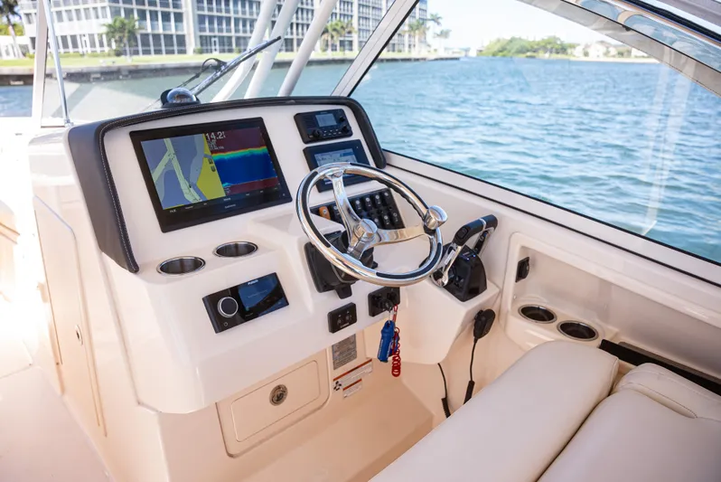  Yacht Photos Pics 2020 Grady-White Freedom 285 boat dashboard with navigation system and steering wheel.
