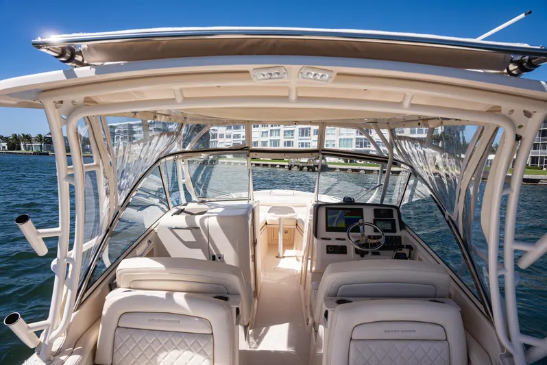  Yacht Photos Pics 2020 Grady-White Freedom 285 boat interior with helm, seats, and waterfront view.