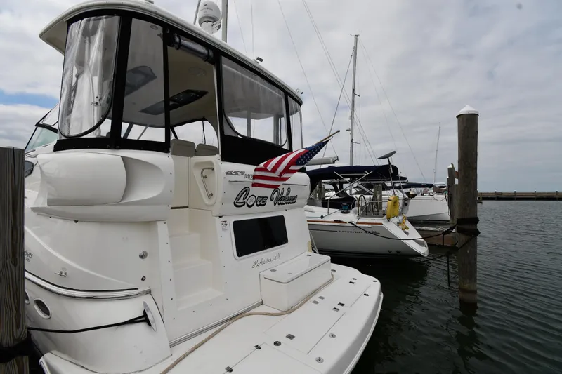 Core Values Yacht Photos Pics 2007 Cruisers Yachts 455 Express Motoryacht docked at marina with American flag.