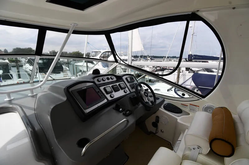 Core Values Yacht Photos Pics 2007 Cruisers Yachts 455 Express Motoryacht helm with modern controls and marina view.
