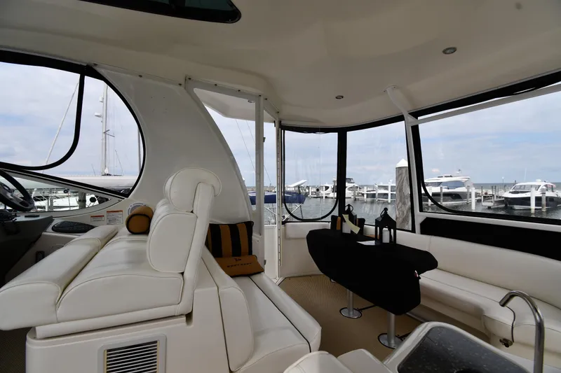 Core Values Yacht Photos Pics Interior of 2007 Cruisers Yachts 455 Express Motoryacht with white seating and marina view.