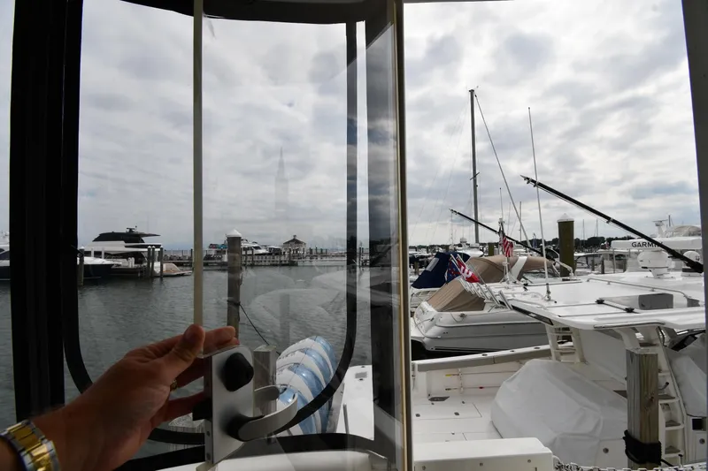 Core Values Yacht Photos Pics Hand opening window on 2007 Cruisers Yachts 455 Express Motoryacht, overlooking marina.