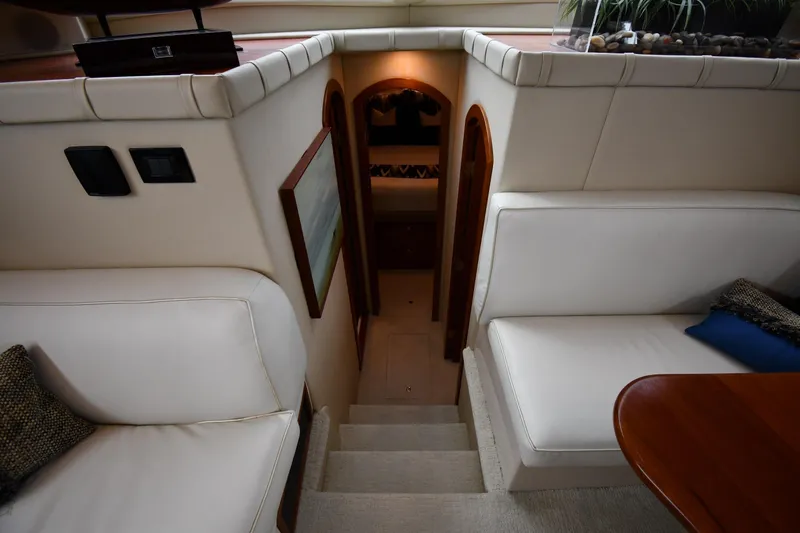 Core Values Yacht Photos Pics Interior of 2007 Cruisers Yachts 455 Express Motoryacht with white seating and wooden accents.
