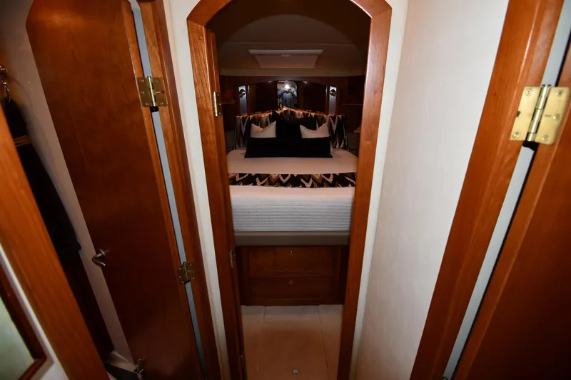 Core Values Yacht Photos Pics Luxurious bedroom interior of 2007 Cruisers Yachts 455 Express Motoryacht with elegant wood finishes.