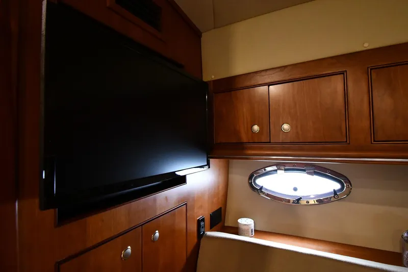 Core Values Yacht Photos Pics 2007 Cruisers Yachts 455 Express Motoryacht interior with TV and porthole window.