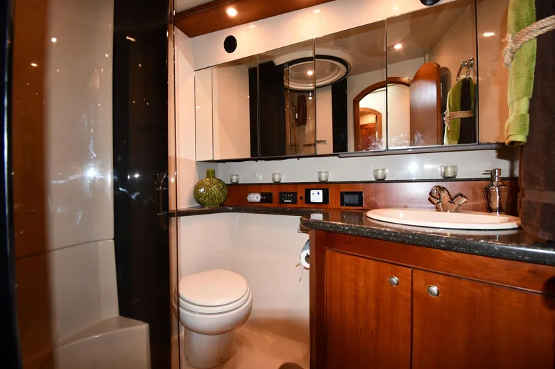 Core Values Yacht Photos Pics Luxurious bathroom in 2007 Cruisers Yachts 455 Express Motoryacht with elegant fixtures and wood cabinetry.
