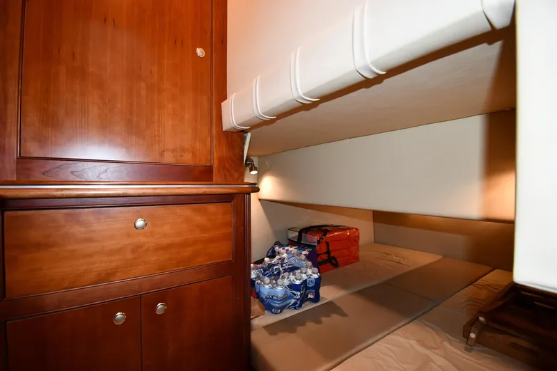 Core Values Yacht Photos Pics 2007 Cruisers Yachts 455 Express Motoryacht cabin with wooden cabinetry and storage space.