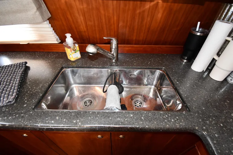 Core Values Yacht Photos Pics 2007 Cruisers Yachts 455 Express Motoryacht kitchen sink with faucet and countertop accessories.