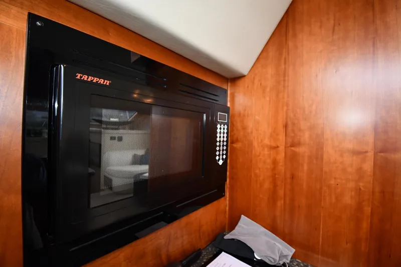 Core Values Yacht Photos Pics Tappan microwave in 2007 Cruisers Yachts 455 Express Motoryacht kitchen, wood paneling background.