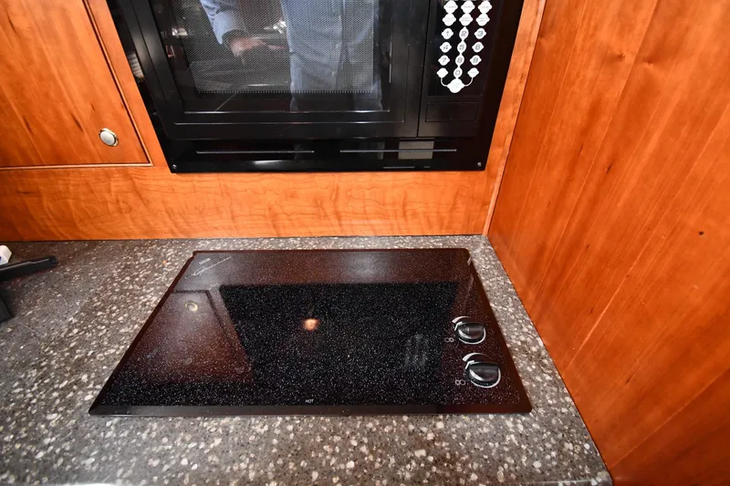 Core Values Yacht Photos Pics 2007 Cruisers Yachts 455 Express Motoryacht kitchen with stovetop and microwave.