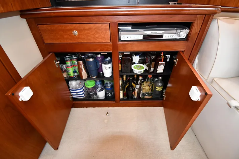 Core Values Yacht Photos Pics 2007 Cruisers Yachts 455 Express Motoryacht interior cabinet with beverages and audio equipment.