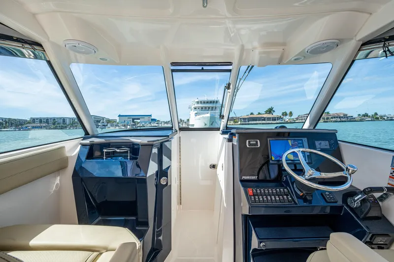 Yacht Photos Pics 2017 Pursuit DC 295 Dual Console boat interior with steering wheel and navigation system.