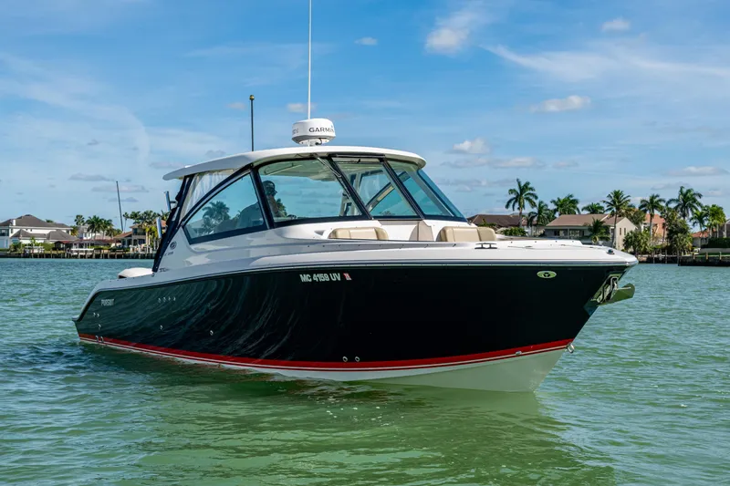  Yacht Photos Pics 2017 Pursuit DC 295 Dual Console boat on calm water, clear sky background.