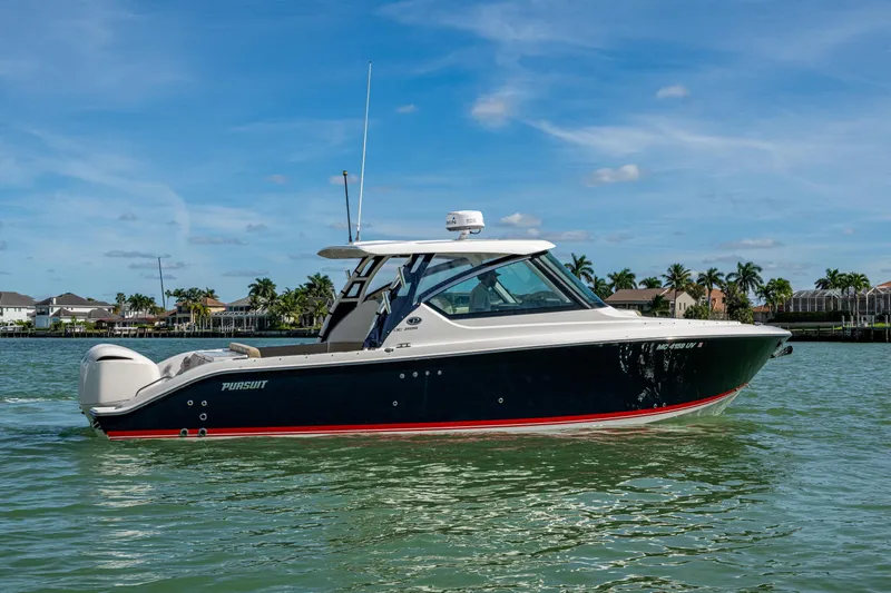  Yacht Photos Pics 2017 Pursuit DC 295 Dual Console boat on calm water, clear sky background.