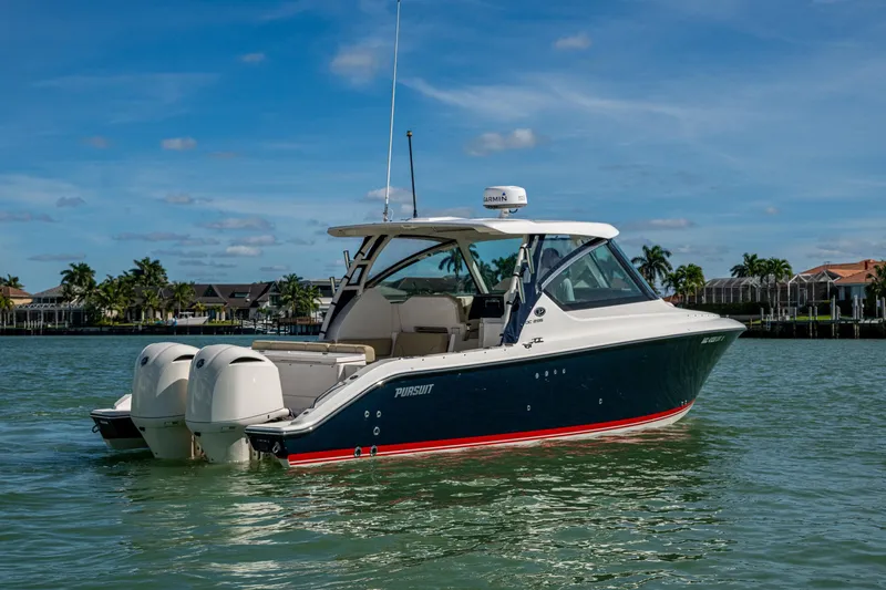  Yacht Photos Pics 2017 Pursuit DC 295 Dual Console boat on calm water, clear sky background.