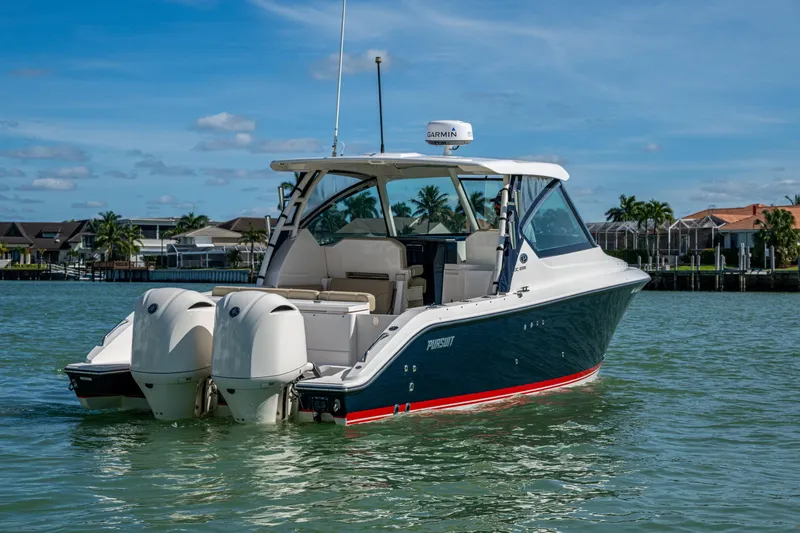  Yacht Photos Pics 2017 Pursuit DC 295 Dual Console boat on water, featuring twin engines.