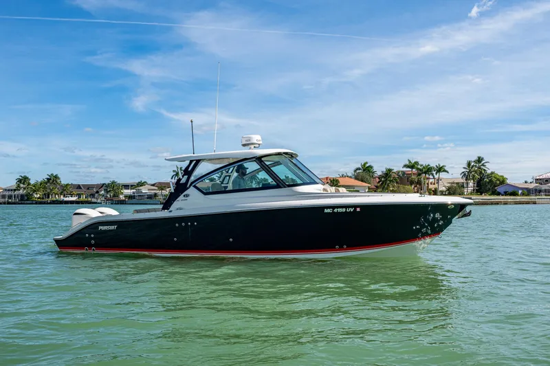  Yacht Photos Pics 2017 Pursuit DC 295 Dual Console boat on calm water, clear sky background.