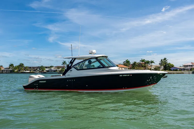  Yacht Photos Pics 2017 Pursuit DC 295 Dual Console boat on calm water, clear sky background.