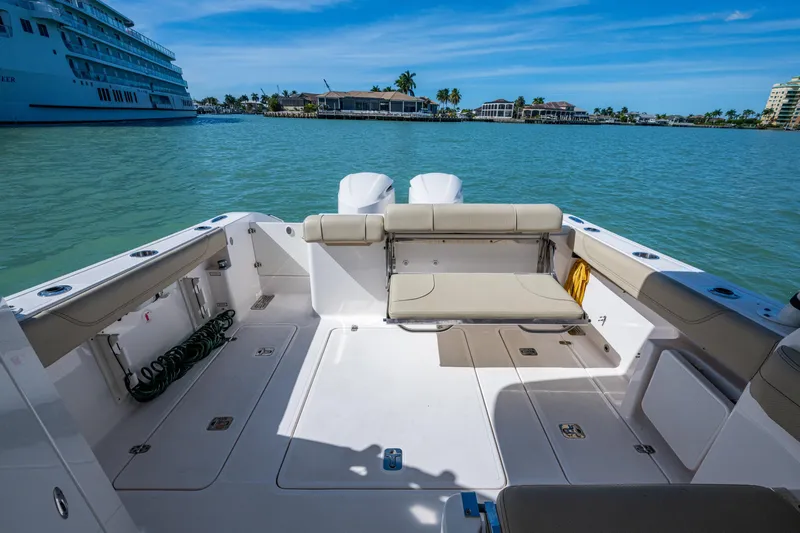  Yacht Photos Pics 2017 Pursuit DC 295 Dual Console boat interior with seating, docked in a scenic marina.