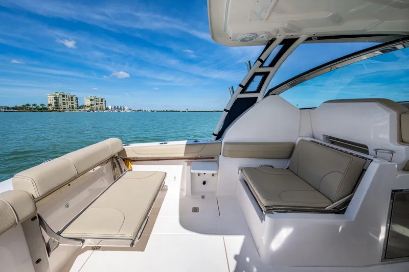  Yacht Photos Pics 2017 Pursuit DC 295 Dual Console boat interior with seating, ocean view, and blue sky.