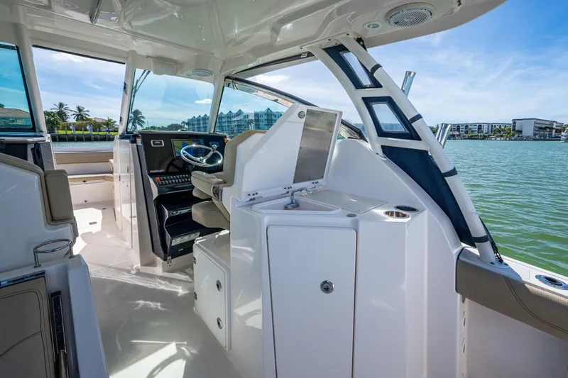  Yacht Photos Pics 2017 Pursuit DC 295 Dual Console boat interior with helm, seating, and water view.