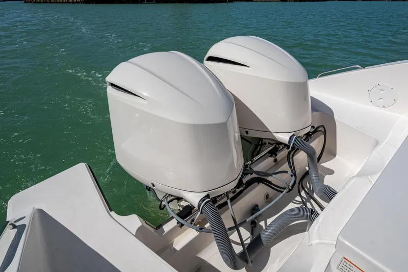  Yacht Photos Pics 2017 Pursuit DC 295 Dual Console boat with twin outboard engines on water.