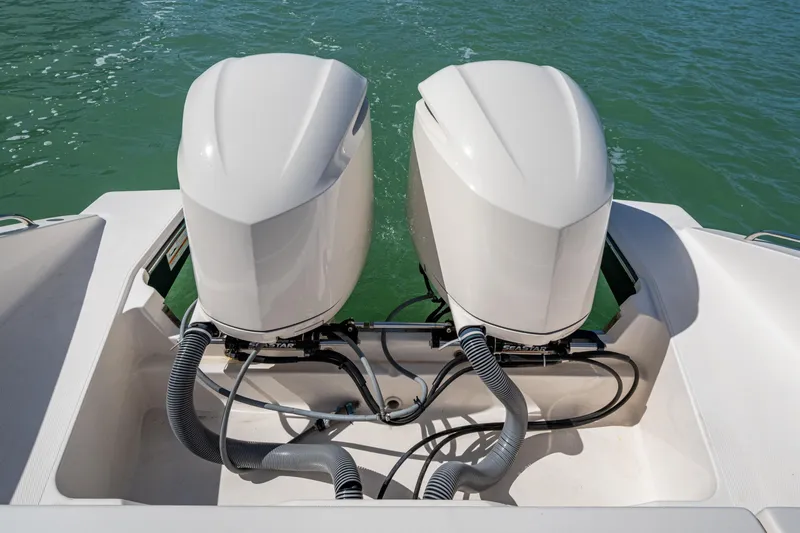  Yacht Photos Pics 2017 Pursuit DC 295 Dual Console boat with twin outboard engines on water.