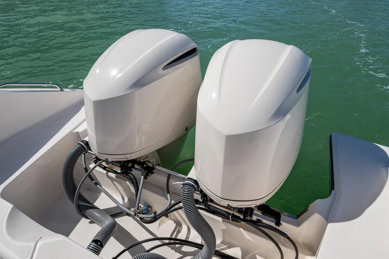  Yacht Photos Pics 2017 Pursuit DC 295 Dual Console boat with twin outboard engines on water.