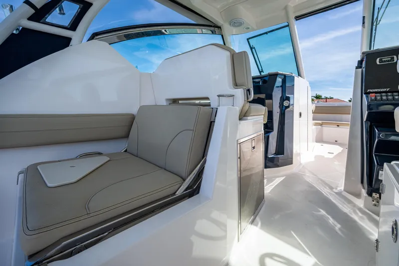  Yacht Photos Pics 2017 Pursuit DC 295 Dual Console interior with seating and helm, showcasing modern design.