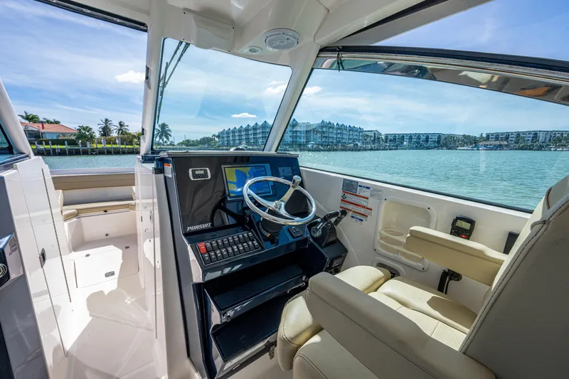  Yacht Photos Pics 2017 Pursuit DC 295 Dual Console boat interior with steering wheel and navigation system.