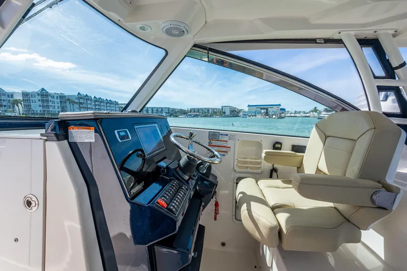  Yacht Photos Pics 2017 Pursuit DC 295 Dual Console boat interior with helm and luxurious seating.