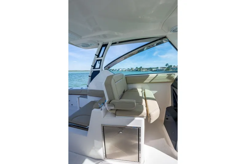 Yacht Photos Pics 2017 Pursuit DC 295 Dual Console interior with beige seating and ocean view.