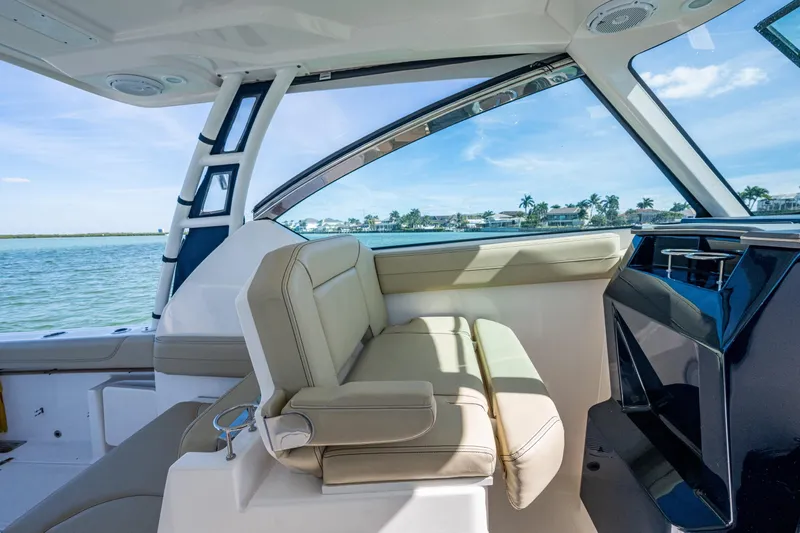  Yacht Photos Pics 2017 Pursuit DC 295 Dual Console interior with beige seating and ocean view.