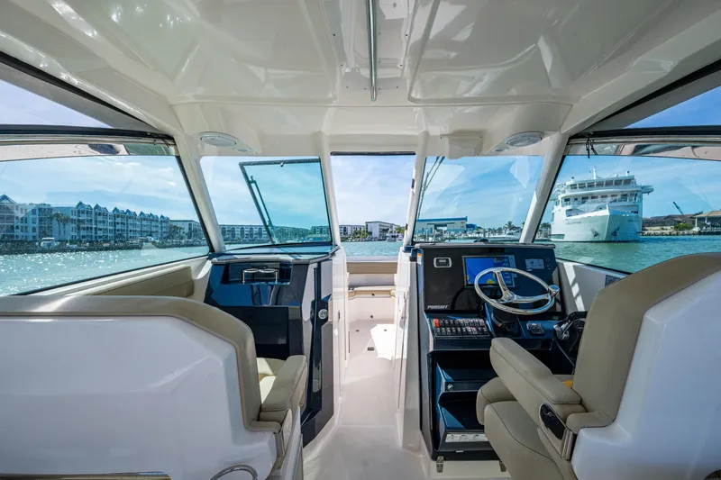 Yacht Photos Pics Interior view of 2017 Pursuit DC 295 Dual Console boat with waterfront scenery.