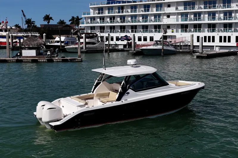  Yacht Photos Pics 2017 Pursuit DC 295 Dual Console boat docked in marina, sunny day.