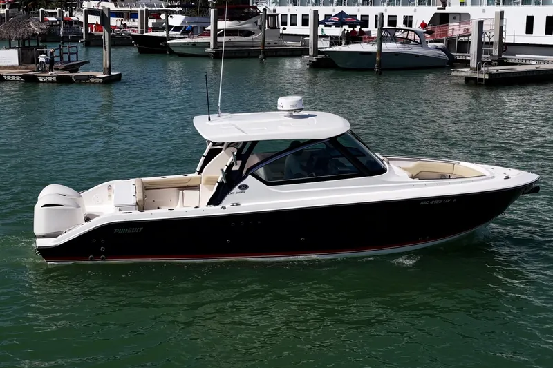  Yacht Photos Pics 2017 Pursuit DC 295 Dual Console boat docked in marina, calm waters, sunny day.