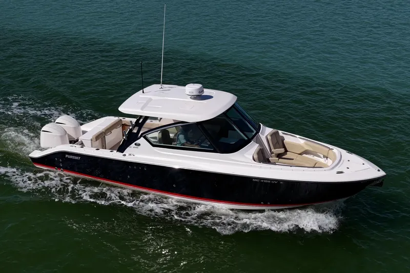  Yacht Photos Pics 2017 Pursuit DC 295 Dual Console boat cruising on open water.