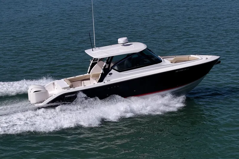  Yacht Photos Pics 2017 Pursuit DC 295 Dual Console boat cruising on open water.