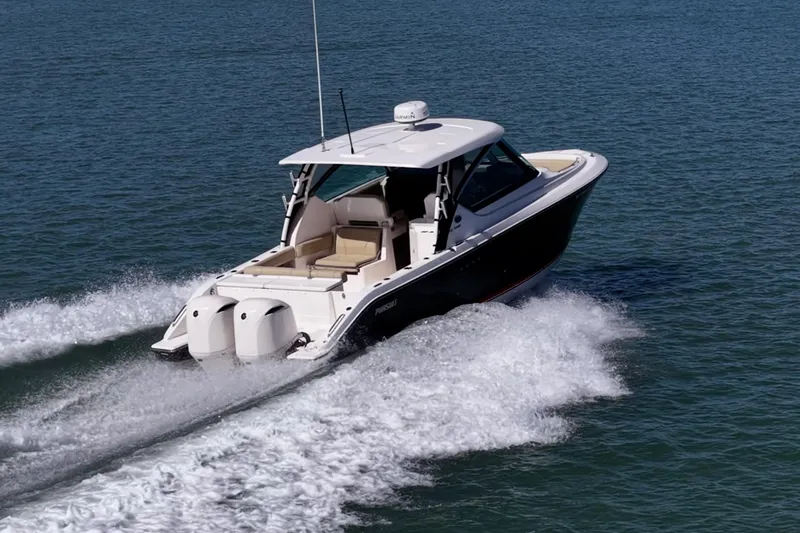  Yacht Photos Pics 2017 Pursuit DC 295 Dual Console boat cruising on open water.