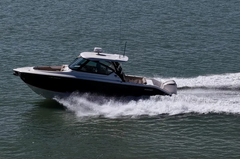  Yacht Photos Pics 2017 Pursuit DC 295 Dual Console boat cruising on open water.