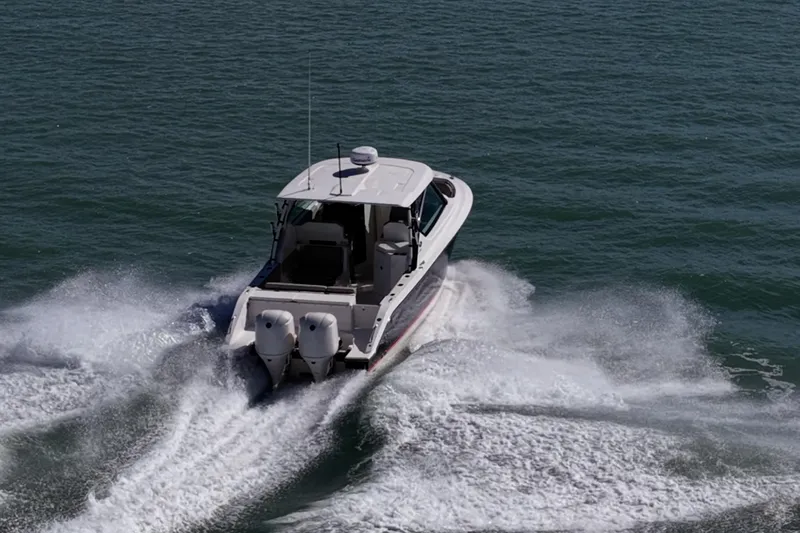  Yacht Photos Pics 2017 Pursuit DC 295 Dual Console boat cruising on open water.