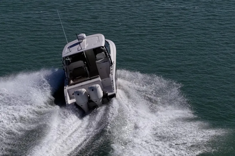  Yacht Photos Pics 2017 Pursuit DC 295 Dual Console boat cruising on open water.