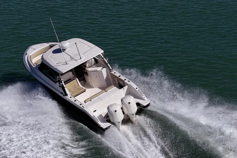  Yacht Photos Pics 2017 Pursuit DC 295 Dual Console boat cruising on open water.