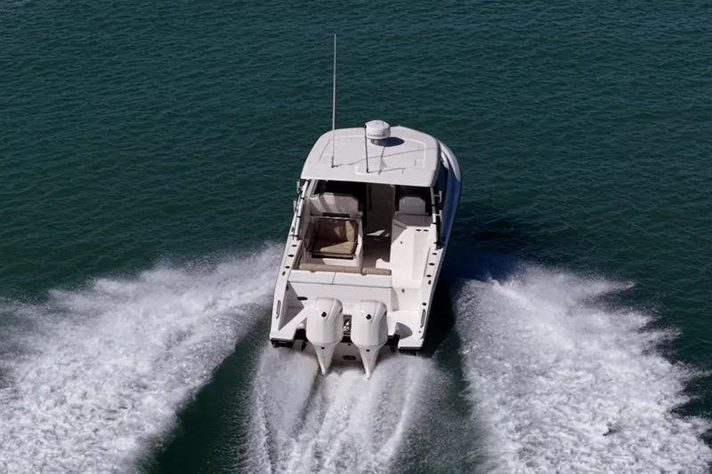  Yacht Photos Pics 2017 Pursuit DC 295 Dual Console boat cruising on open water.