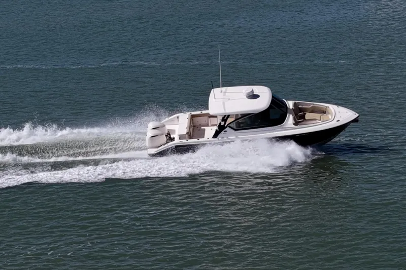  Yacht Photos Pics 2017 Pursuit DC 295 Dual Console boat cruising on open water.
