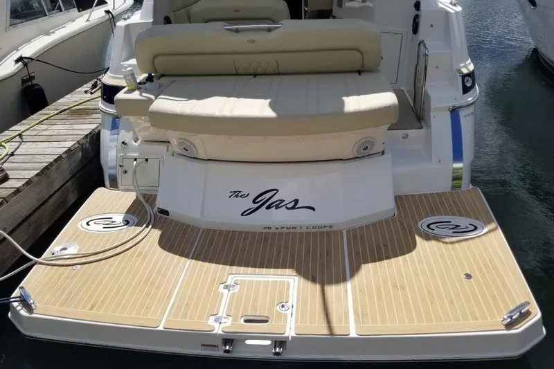 Ships N Giggles Yacht Photos Pics 2018 Regal 35 Sport Coupe boat with teak swim platform and cushioned seating.
