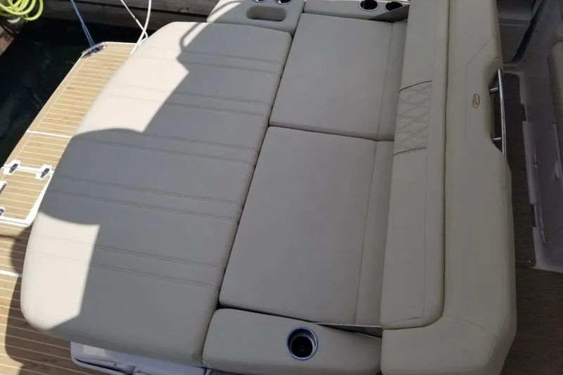 Ships N Giggles Yacht Photos Pics 2018 Regal 35 Sport Coupe boat with beige cushioned seating and cup holders.