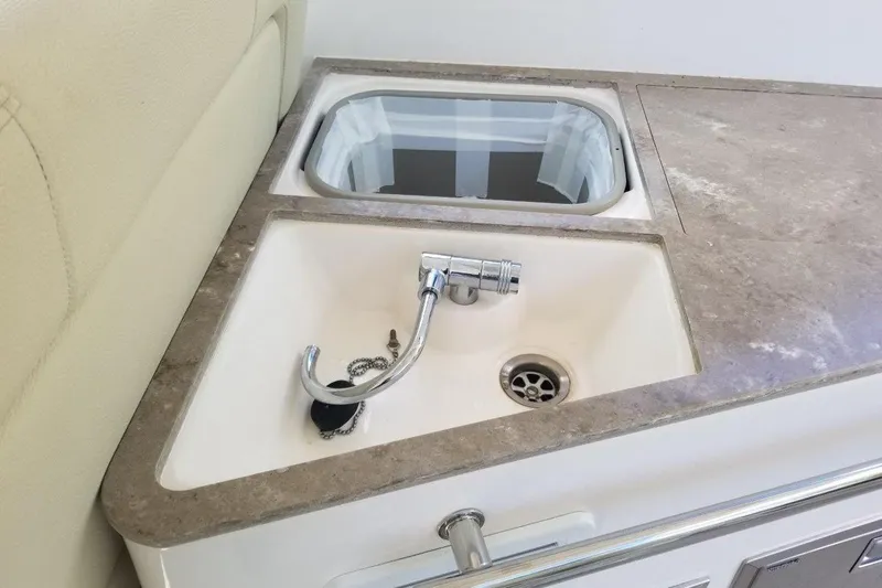 Ships N Giggles Yacht Photos Pics 2018 Regal 35 Sport Coupe boat sink with faucet and countertop.
